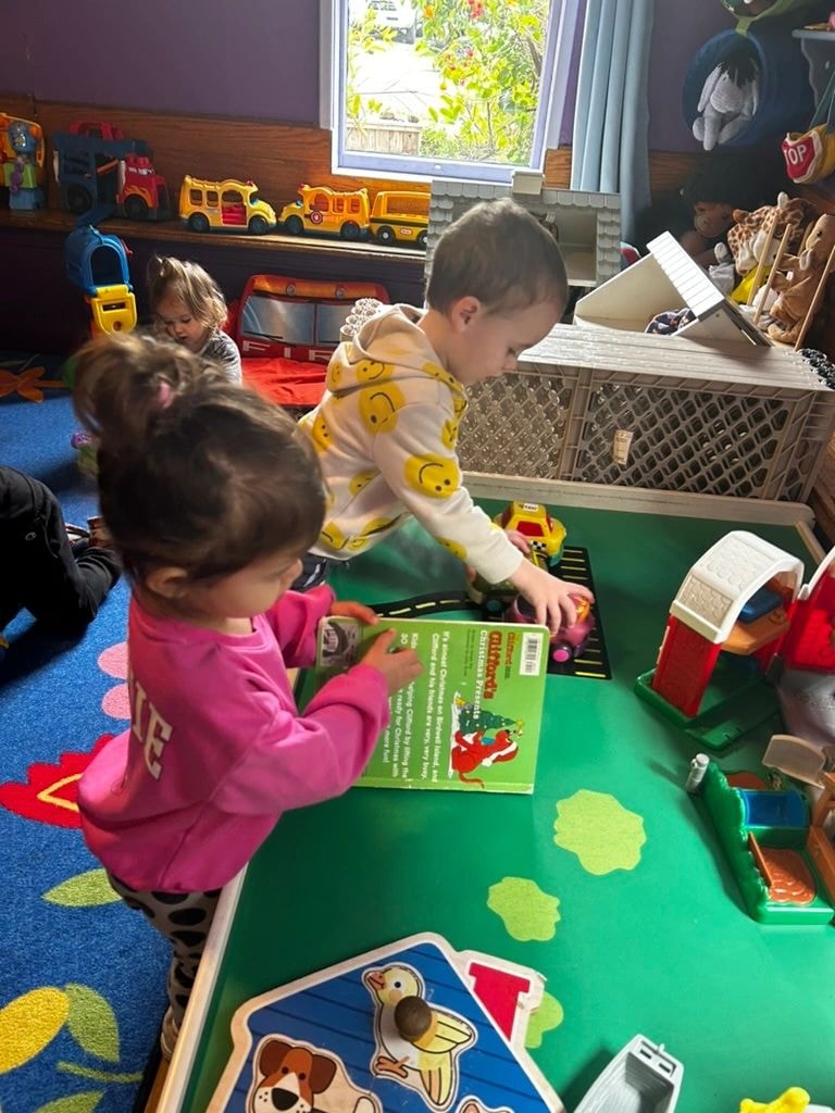 Children engaged in interactive learning at a classroom table